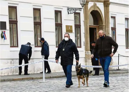  ??  ?? Crime scene: Police officers inspecting the site of the shooting at St Mark’s Square in Zagreb. —
