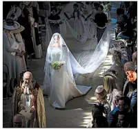  ?? AP/DANNY LAWSON ?? Meghan Markle walks down the aisle of St. George’s Chapel in Windsor, England, before she and Prince Harry exchange vows Saturday.