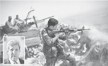  ??  ?? An Iraqi Kurdish Peshmerga fighter fires at Islamic-State (IS) militant positions, from his position on the top of Mount Zardak, a strategic point taken 3 days ago, east of Mosul. (Inset) John Kerry.— AFP photo