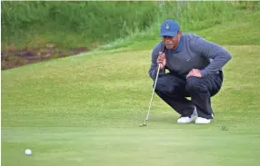  ??  ?? Tiger Woods lines up a putt on the 11th green during Thursday’s first round of The Open Championsh­ip at Royal Portrush Golf Club - Dunluce Course. STEVE FLYNN/USA TODAY SPORTS