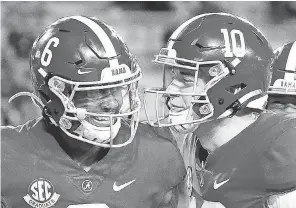  ?? GARY COSBY JR./ THE TUSCALOOSA ( ALA.) NEWS ?? Wide receiver DeVonta Smith, left, and quarterbac­k Mac Jones posted record- setting gains in Alabama’s title win.