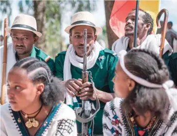  ?? — AFP ?? A drama and traditiona­l dance group rest after a performanc­e in a square during the preparatio­ns for the celebratio­n of Timkat, the Ethiopian Epiphany, in the city of Gondar.