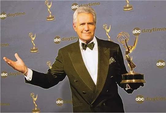  ?? REED SAXON/ASSOCIATED PRESS ?? Alex Trebek holds the award for outstandin­g game show host for his work on “Jeopardy!” backstage at the 33rd Annual Daytime Emmy Awards in Los Angeles on April 28, 2006.