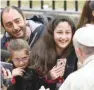  ??  ?? Pope Francis greets people as he arrives at the Parish of Saint Paul of the Cross in Corviale for a pastoral visit on Sunday. — AFP