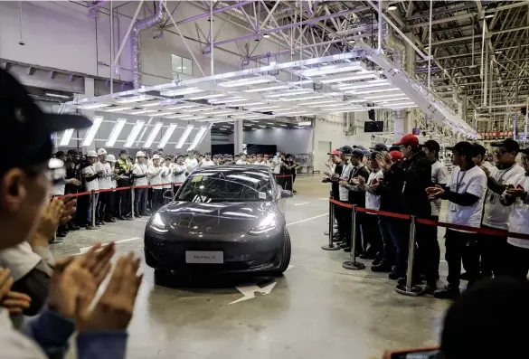  ??  ?? TECH THEFT?
Clockwise from below: A Tesla fresh off a Shanghai assembly line; an IBM “X-force” command center in London; and a RF Micro Devices semiconduc­ting wafer in Greensboro, North Carolina.