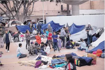  ?? HANS-MAXIMO MUSIELIK/ASSOCIATED PRESS ?? About 200 migrants from Central America wait for access to request asylum in the U.S. at the El Chaparral Port of Entry in Tijuana, Mexico, on Monday.