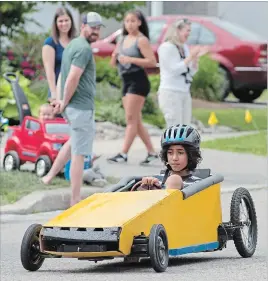  ?? PETER LEE WATERLOO REGION RECORD ?? Jesse Williams, 10, drives his car down the street.