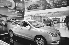  ??  ?? Automobile­s are displayed at a electric car dealership in Shanghai. More electric cars are sold in China than in the rest of the world combined, but are mainly locally-branded models that are cheaper and have a shorter range than those offered by...