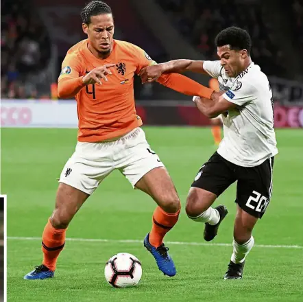 ?? — Reuters ?? Eyes on the ball: Holland’s Virgil van Dijk (left) in action against Germany’s Serge Gnabry during the European Championsh­ip qualifiers Group C match in Amsterdam on Sunday. Inset: Northern Ireland’s Josh Magennis celebratin­g after scoring the second goal against Belarus.
