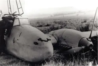  ??  ?? ■ A soldier of the 7th Devonshire Regiment investigat­es the cockpit of the crashed Messerschm­itt. Could he be removing or eyeing-up the three items which are the feature of this ararticle?