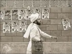 ?? REUTERS ?? A man walks past a wall with political posters ahead of general elections, Karachi, Pakistan. The elections are scheduled for July 25