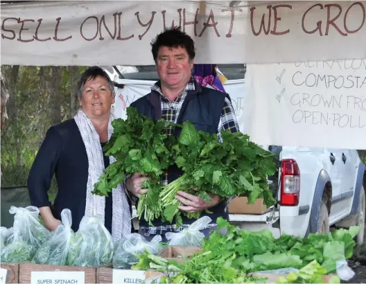  ??  ?? ▲ Organic farmer Steve Standish, inaugural president of the Noosa PGS, with wife Tina at the Noosa Farmers’ Market, selling certified organic produce grown on their property at Federal, in Noosa’s Hinterland on the Sunshine Coast, Queensland.