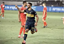  ?? (Ariel Shalom) ?? MACCABI TEL AVIV forward Eylon Almog celebrates after scoring the yellow-and-blue’s second goal during stoppage time of the club’s 2-0 derby victory over Hapoel Tel Aviv at Bloomfield Stadium in Premier League Championsh­ip Playoff action.