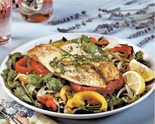  ?? ABEL URIBE/CHICAGO TRIBUNE PHOTOS; SHANNON KINSELLA/FOOD STYLING ?? The Provencal-style fish salad, made here with broiled tilapia, is inspired by the bounty of tomatoes, onion, garlic and bell peppers at the farmers market.