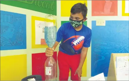  ?? ZACHARY SRNIS — THE MORNING JOURNAL ?? Devyn Krzak, 10, of Lorain, demonstrat­es his homemade tornado at a summer camp at Lorain Historical Society Carnegie Center at 329W. 10th St. in Lorain.