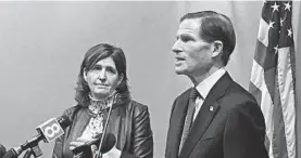  ?? SUSAN HAIGH/AP ?? Karen Jarmoc, left, CEO of the Connecticu­t Coalition Against Domestic Violence, stands with Sen. Richard Blumenthal, D-Conn., at a news conference Dec. 27 in Hartford.
