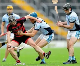  ??  ?? Tight: Ballygunne­r’s JJ Hutchinson is held by Mike Casey