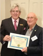  ??  ?? President of the Royal Victorian Associatio­n of Honorary Justices Norman Wittingslo­w (left) presents Malcolm Dickson with a certificat­e recognisin­g his 35 years of service.