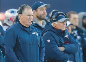  ?? AP ?? Patriots coach Bill Belichick watches a game from the sidelines with offensive line coach Dante Scarnecchi­a.