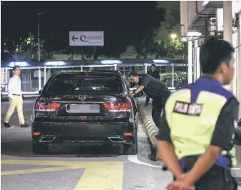  ??  ?? A police officer talking to the driver of a North Korean Embassy vehicle at Institute of Forensic Medicine at Kuala Lumpur Hospital. — Bernama photo