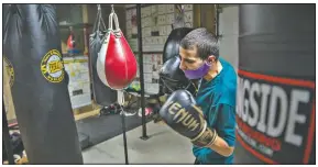  ??  ?? When not hitting the bags in the gym, Alex Mazzarisi, hits the books for classes at Sauk Valley College in Dixon, Ill.