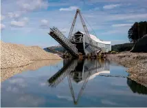  ?? FILE ?? The gold dredge on the Grey River at Ngahere, 10km upstream from Michael Reedy’s claim. Since 1987, this 3500-tonne monster – a far cry from Reedy’s suction dredge – has mined 55,000 ounces (1.56 tonnes) of gold from 220ha of goldbearin­g gravels.