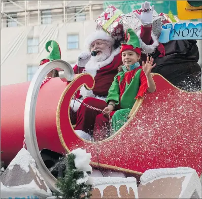  ?? RICHARD LAM/PNG ?? Jolly old St. Nick, accompanie­d by two enthusiast­ic elves, waves to the crowd at the end of the annual Rogers Santa Claus Parade in downtown Vancouver on Sunday.