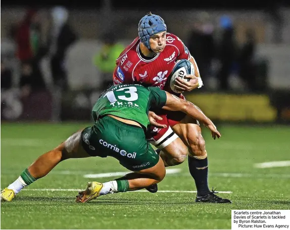  ?? ?? Scarlets centre Jonathan Davies of Scarlets is tackled by Byron Ralston.
Picture: Huw Evans Agency