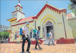  ?? PTI ?? Municipal corporatio­n workers sanitise the Residency Road Church in Jammu on Sunday. The administra­tion has announced that religious places will continue to remain closed in the UT.