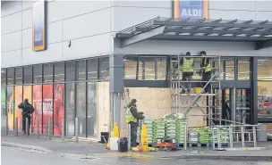  ??  ?? ●●Repairs being made to Aldi store the morning after the crash