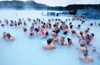  ?? ODDGEIR KARLSSON/BLUE LAGOON ?? The Blue Lagoon pools are filled with geothermal seawater and deposits of silica, blue green algae and minerals.