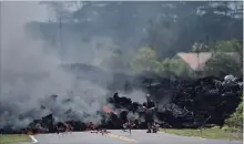  ?? MARCO GARCIA
THE ASSOCIATED PRESS ?? A man films the lava in the Leilani Estates subdivisio­n in Pahoa, Hawaii.