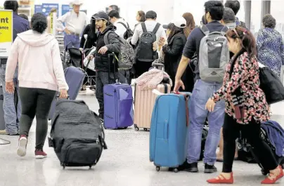  ?? Melissa Phillip / Staff photograph­er ?? It was busy during the holidays in 2018 at Terminal A at Bush Interconti­nental Airport, and it will be even busier this year. Across the country, a record 31.6 million passengers are expected to fly from Friday through Dec. 3.
