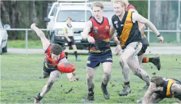  ??  ?? Longwarry’s Brody Rundell slips as he attempts to win possession.