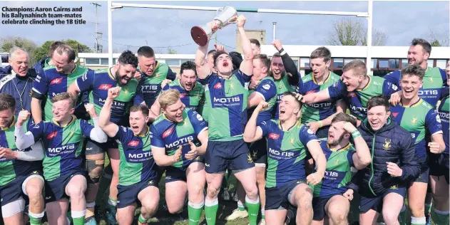  ??  ?? Champions: Aaron Cairns and his Ballynahin­ch team-mates celebrate clinching the 1B title