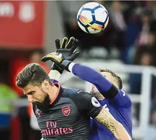  ??  ?? Up for it: Stoke’s Jack Butland (right) and Arsenal’s Olivier Giroud going for the ball at the Bet365 Stadium in Stoke on Saturday. — AP