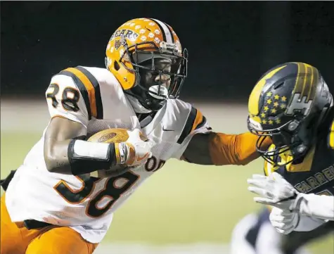  ?? Justin K. Aller/For the Post-Gazette photos ?? Clairton’s Lamont Wade carries in a PIAA Class 1A semifinal against Farrell Friday at Slippery Rock University. Wade gained 248 yards in the victory for the Bears.