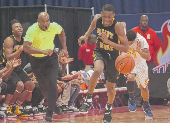  ?? | WORSOM ROBINSON/ FOR THE SUN- TIMES ?? Joliet West’s Teyvion Kirk ( 27 points on 10- for- 11 shooting) chases down a loose ball in the first half against North Lawndale on Saturday.