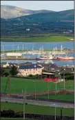  ?? AP/T. DUNCAN ABERNATHY ?? Boats float in the harbor against a backdrop of lush, rolling hills in Dingle, Ireland. The town on Ireland’s southwest coast has a lively pub scene.