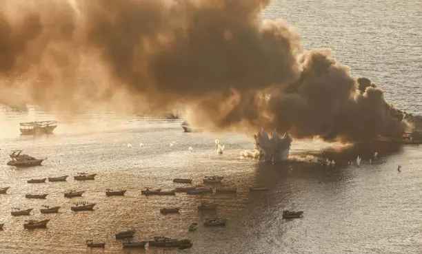  ?? ?? Fire and smoke rise after Israel struck a fishing boat in the seaport of Gaza City, in October 2023. — Source: Ahmed Zakot/SOPA/ZUMA