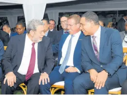  ?? ?? Prime Minister Andrew Holness (right) shares lens with Dr Ralph Gonsalves, prime minister of St Vincent and the Grenadines (left), and Adam Stewart, executive chairman, Sandals Resorts Internatio­nal.