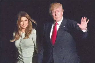  ?? AP-Yonhap ?? U.S. president Donald Trump and first lady Melania Trump walk from Marine One across the South Lawn to White House in Washington, Saturday, as they return from Sigonella, Italy.