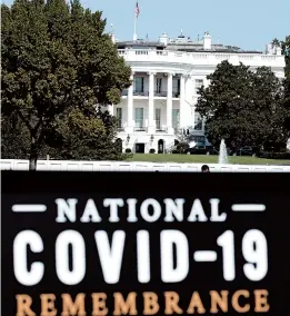  ?? JOSE LUIS MAGANA/AP ?? A sign for the COVID-19 Remembranc­e is seen Sunday near the White House. President Trump returned home Monday after a brief stay at a military medical hospital.