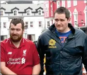  ?? Photo by Michelle Cooper Galvin ?? Garda James Fairbrothe­r arriving with Thomas Mahony (left) at Killarney Courthouse on Tuesday.