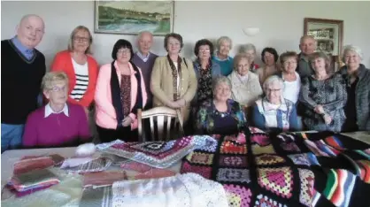  ??  ?? Members of the Sean Cháirde group display their impressive quilts, the fruits of new project that provides comfort for refugees.
