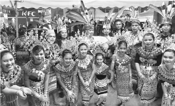  ??  ?? Performers take a break during a special show at Gawai Dayak Bazaar 2017 in Eastern Mall in Siburan, near Kuching.