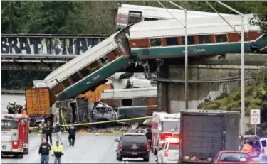  ?? ELAINE THOMPSON — ASSOCIATED PRESS ?? Cars from the derailed Amtrak train hang from a highway overpass.