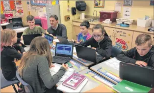  ?? SUBMITTED PHOTO ?? Paradise Elementary School principal Michel Tobin has been chosen as one of Canada’s outstandin­g principals for 2018. He is shown using technology with several of his students, a key component at Paradise Elementary.