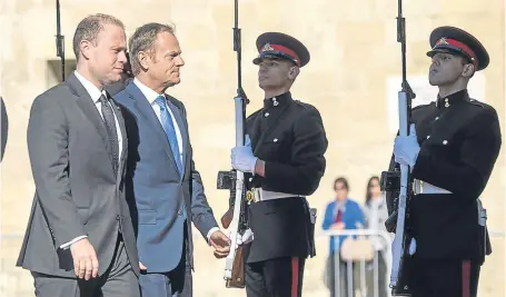  ?? Picture: AP. ?? Donald Tusk, President of the European Council, second from left, is greeted by the Maltese Prime Minister Joseph Muscat outside his office in Castille, Valletta.