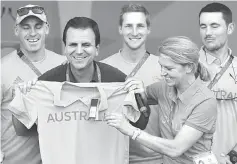  ??  ?? Kitty Chiller, Chef de Mission for Australia at the Rio 2016 Olympic Games, gives Australia t-shirt to Rio’s mayor Eduardo Paes during a welcome ceremony he arranged for them at the Olympic village in Rio de Janeiro, Brazil. — Reuters photo